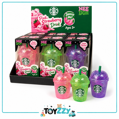 A display of Starbucks-branded Nee Doh Pink Strawberry Drink toy cups in a black retail box, with three loose toy cups in front showing pink, green, and purple glittery drink designs on a white background.