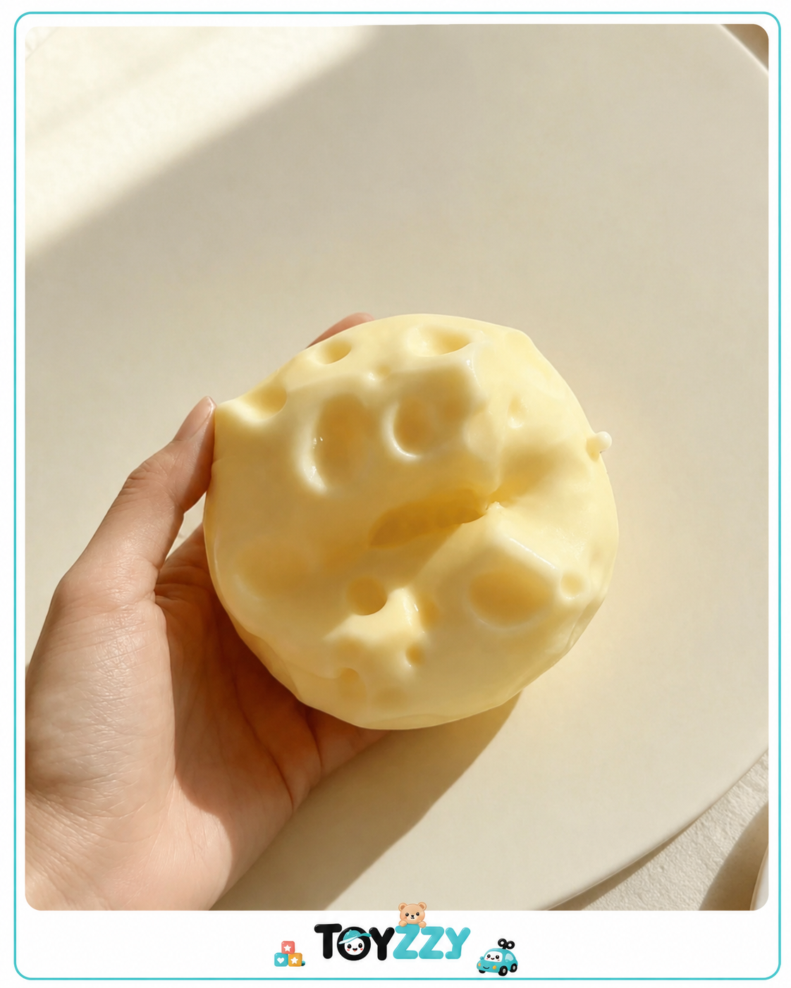 Gooey cheese cube squishy being squeezed by hand